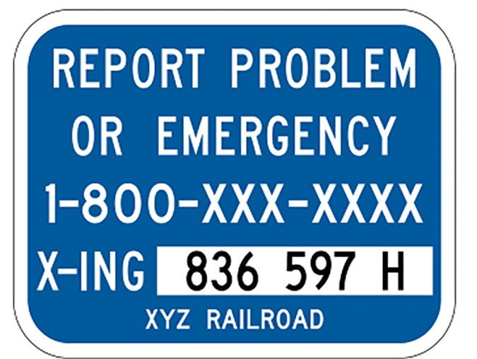 The blue ENS sign has the crossing number and railroad phone number. 